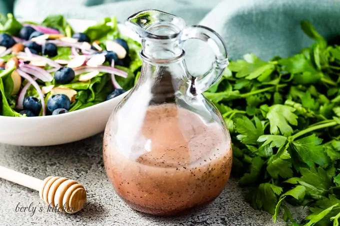 The poppy seed salad dressing in a dressing bottle.