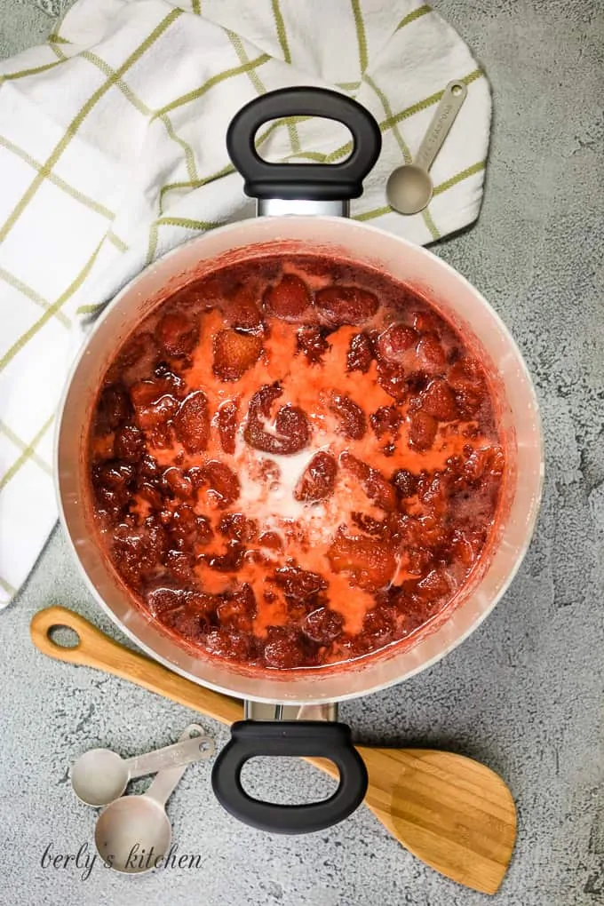 A corn starch slurry has been added to the cooked berries.