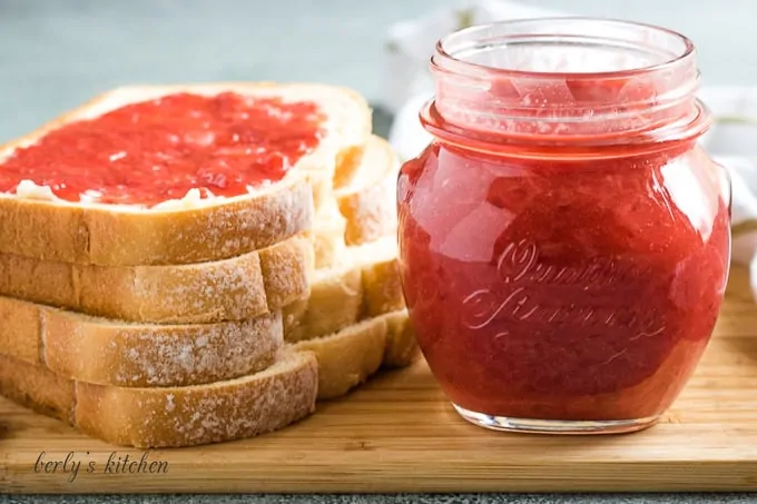 The finished strawberry jam on toast and a mason jar.