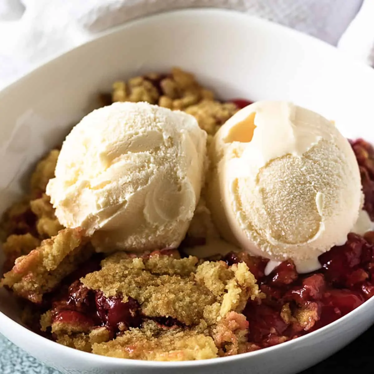 The cherry dump cake served with vanilla ice cream.