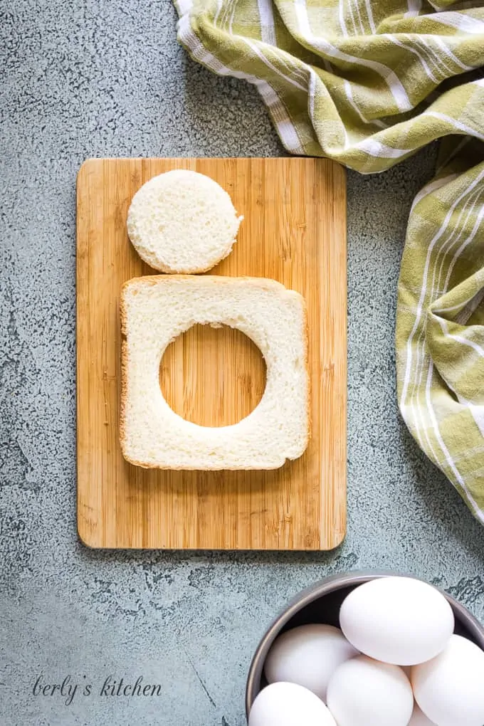 A piece of bread with circular hole cut in the middle.