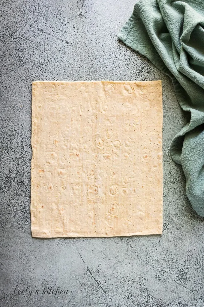 The flatbread has been placed on the counter.