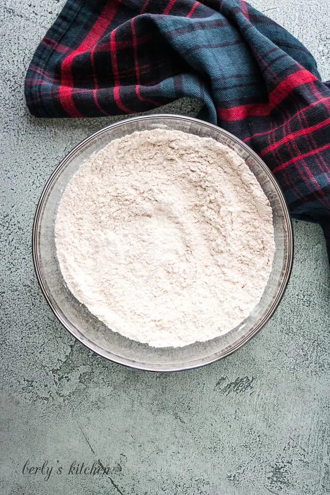 Flour, cinnamon, baking soda, and salt mixed in a bowl.