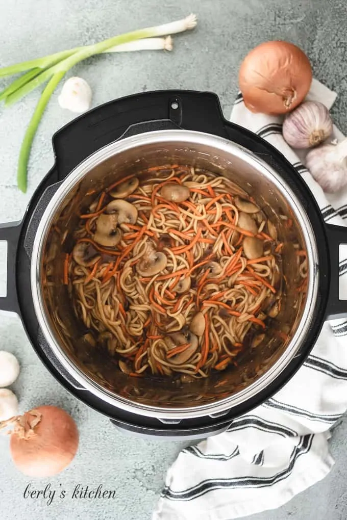 Carrots and the soy sauce mixture have been added to the pot.