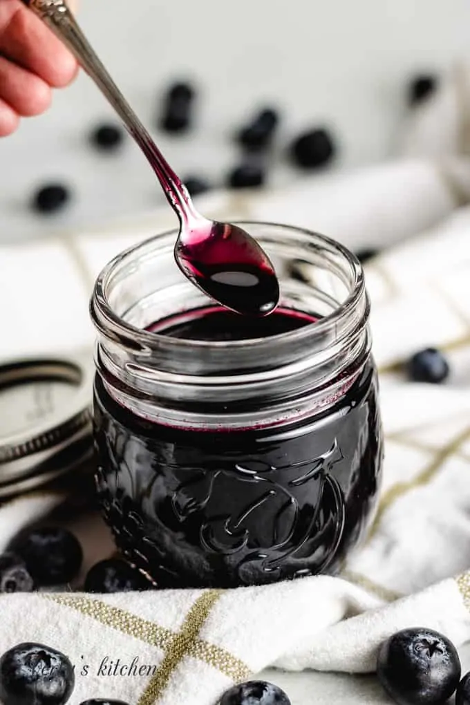 A small spoon being dipped into the simple syrup.