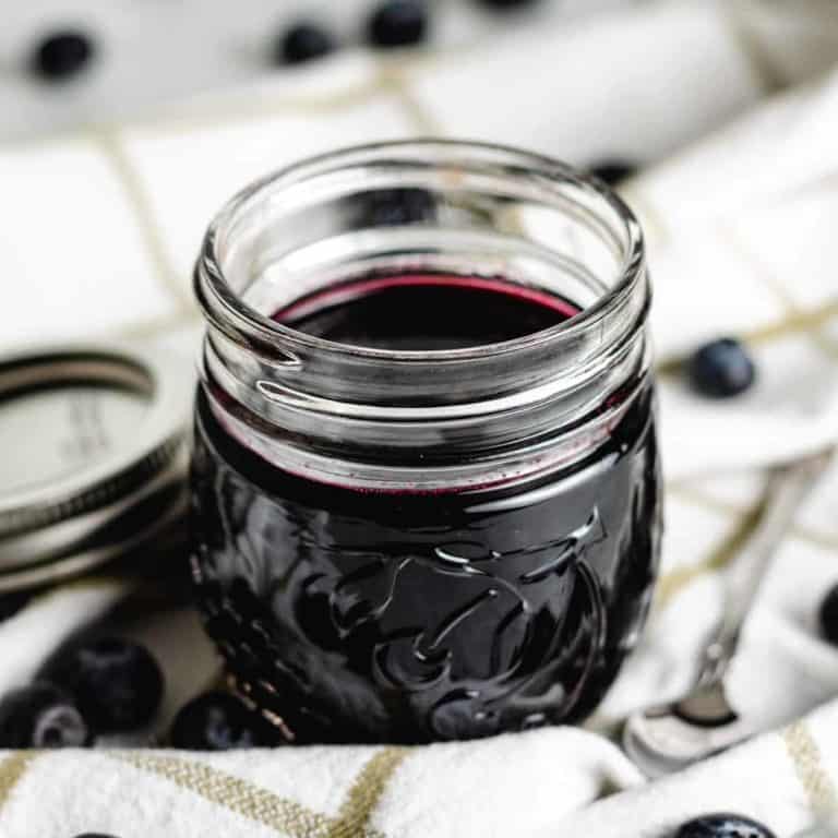 The blueberry simple syrup in a mason jar.