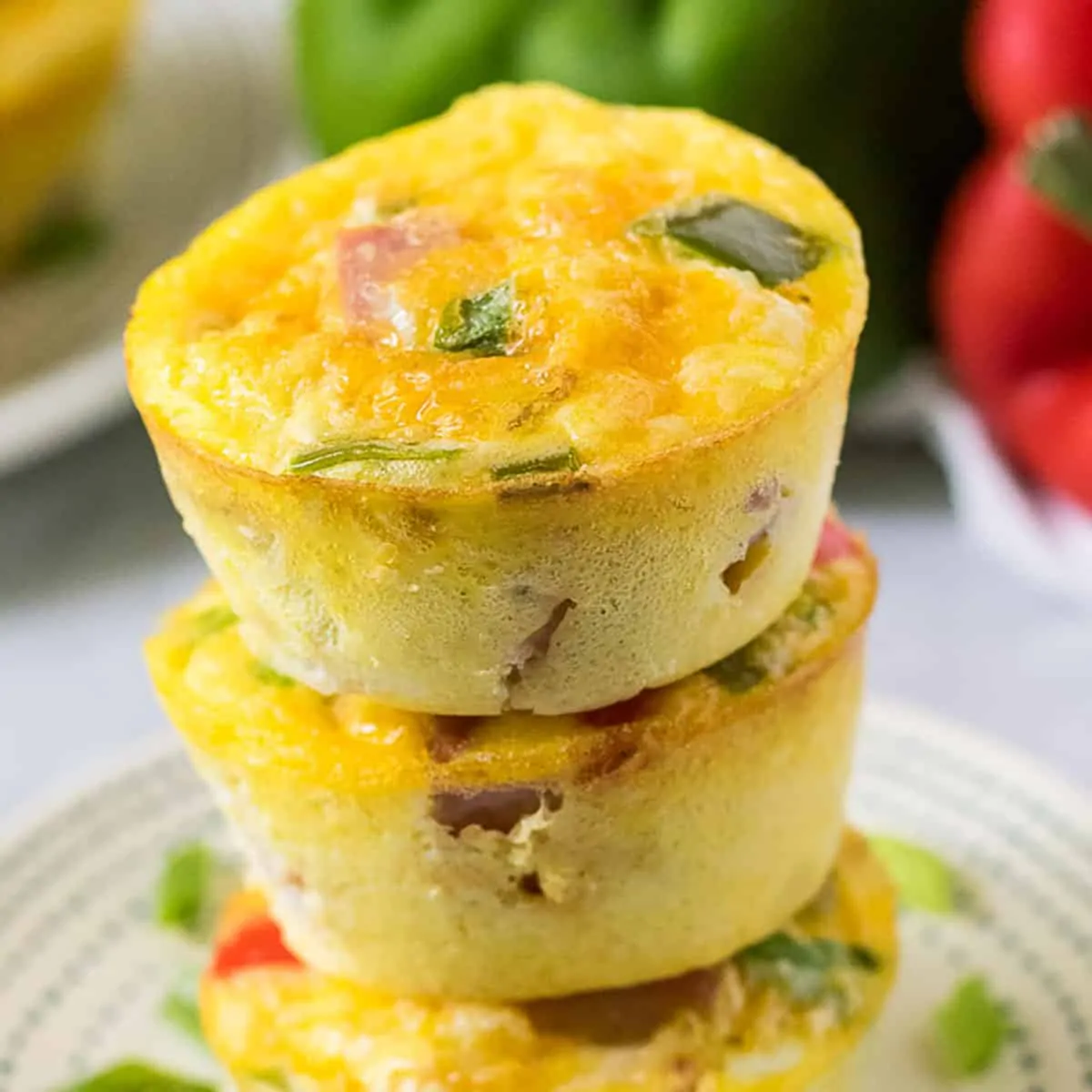 Stack of omelette egg muffins on a blue and white plate.