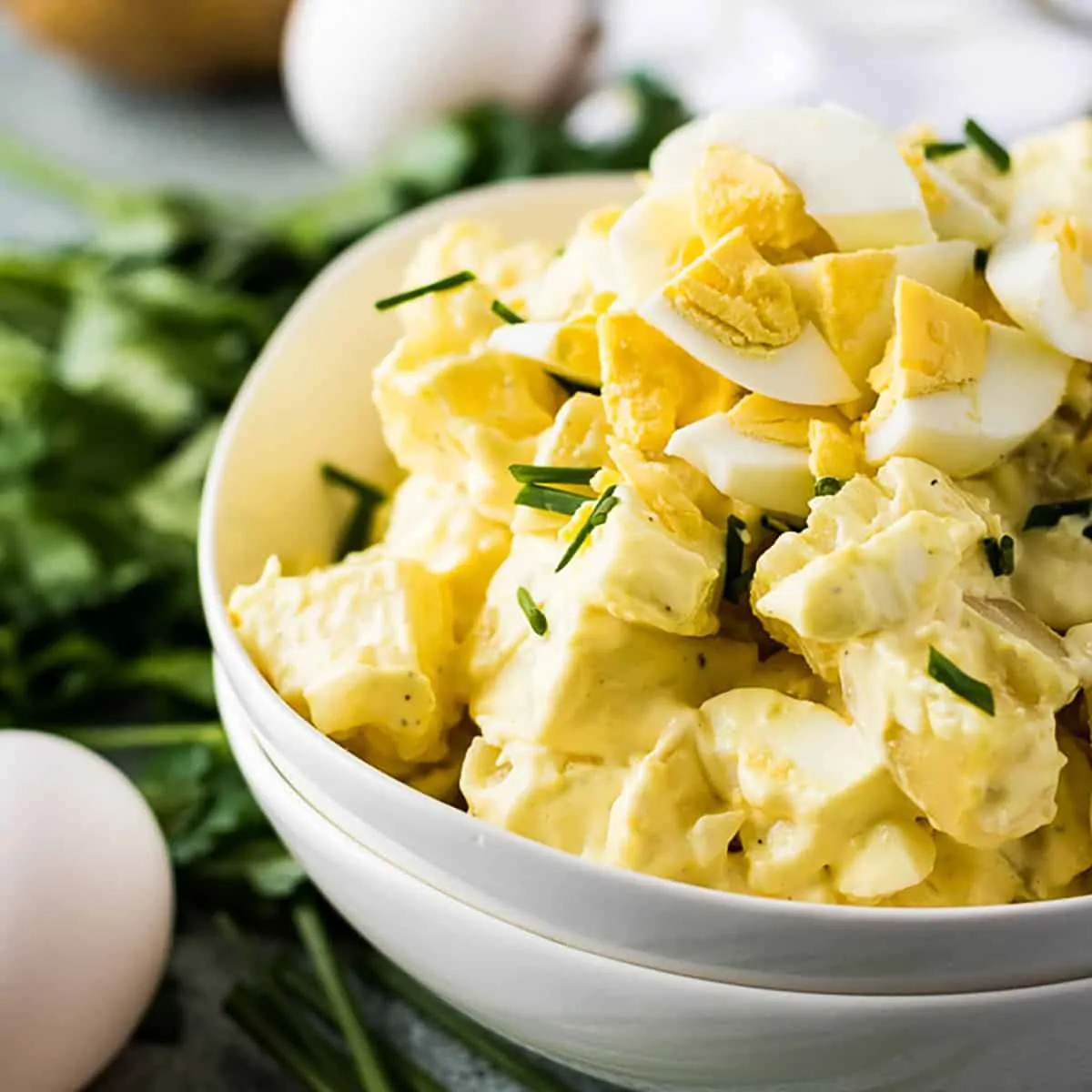 Instant pot potato salad topped with chopped eggs and chives.