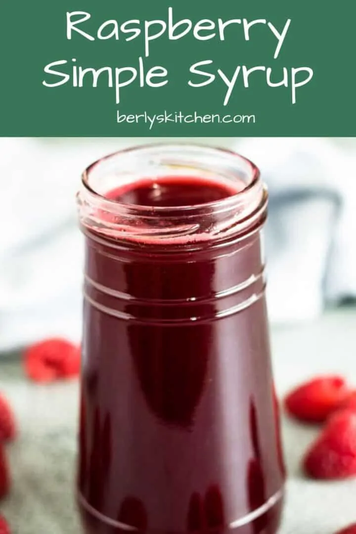 A close-up view of the raspberry simple syrup in a jar.