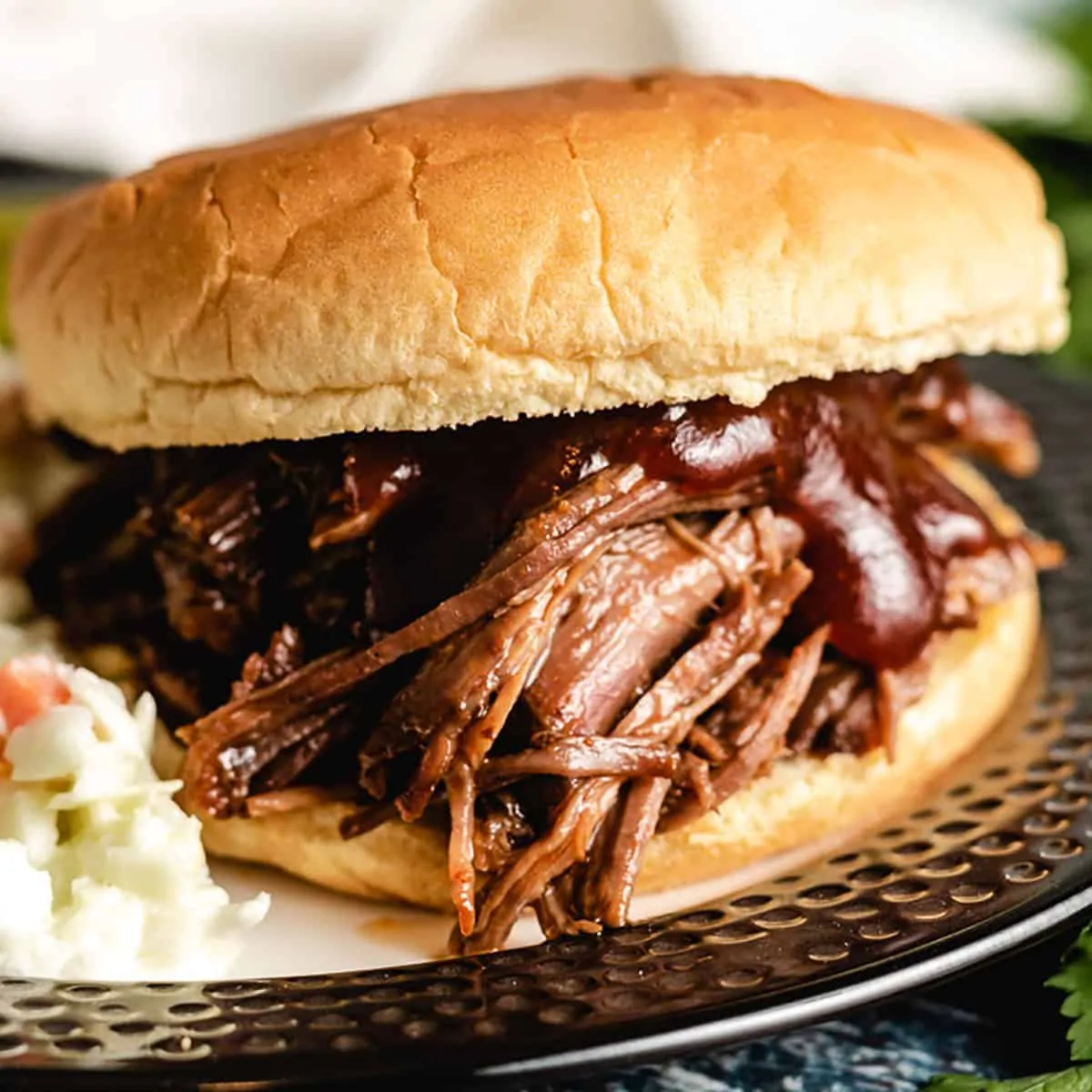 The shredded bbq beef sandwich served with coleslaw.