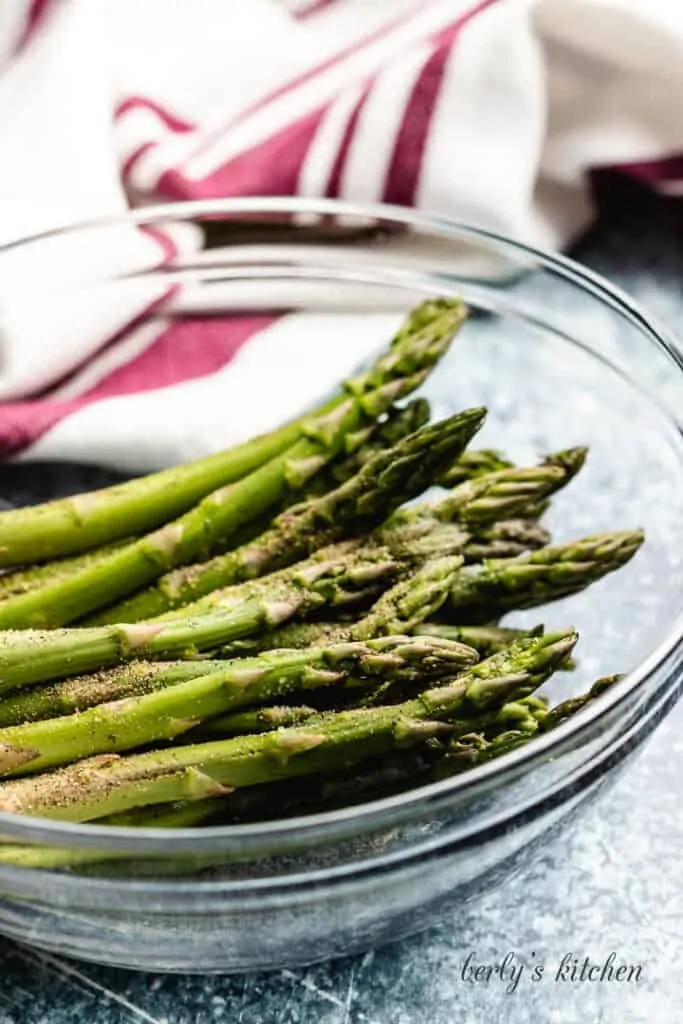 The trimmed asparagus in a mixing bowl.