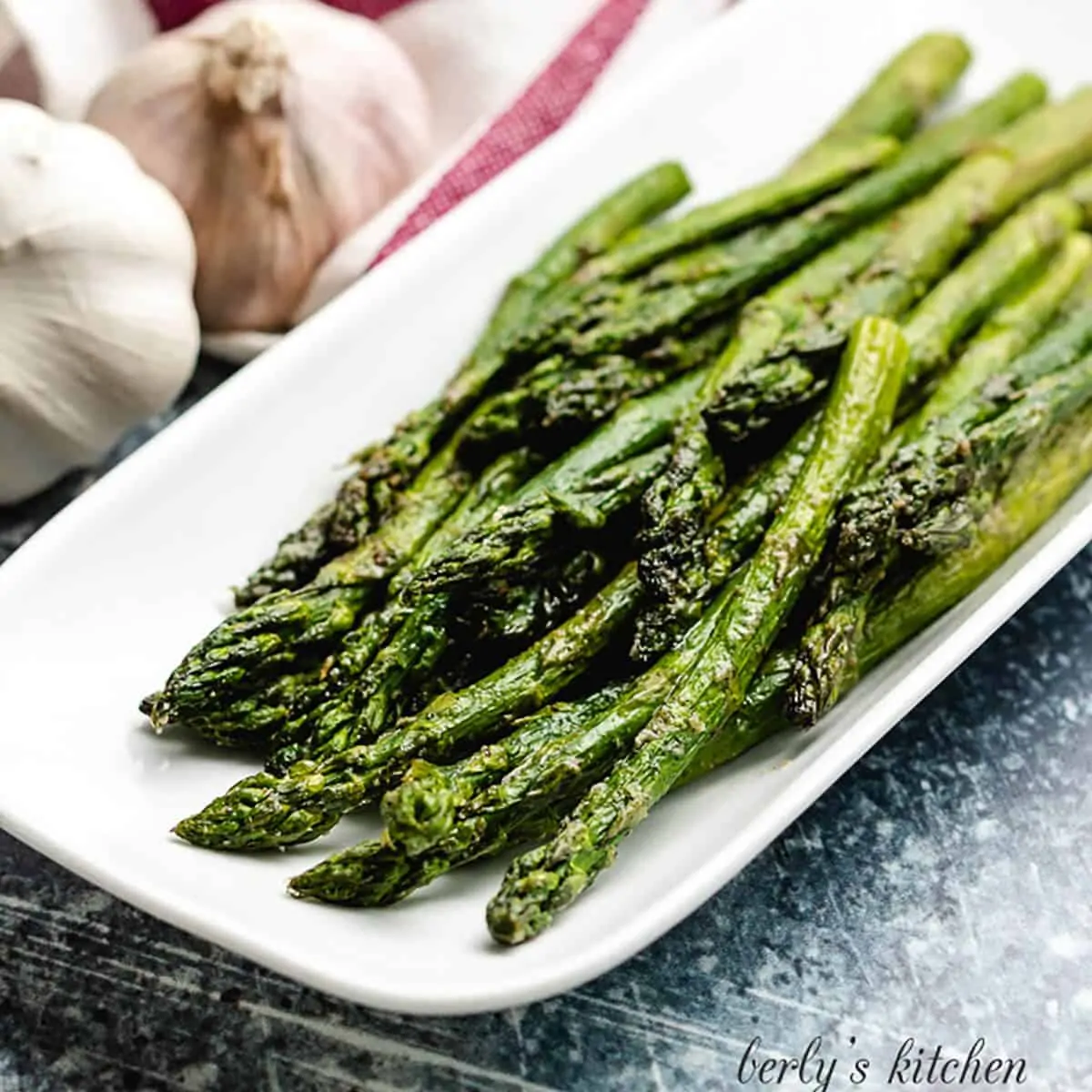 Seasoned air fryer asparagus served on a platter.