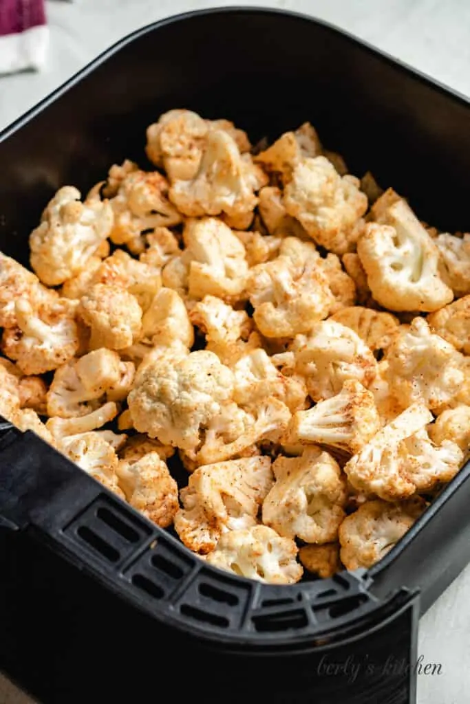 The florets sitting in the fryer basket.