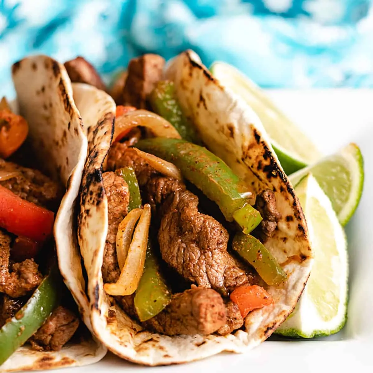 A close-up of the flat iron steak fajitas on a plate.