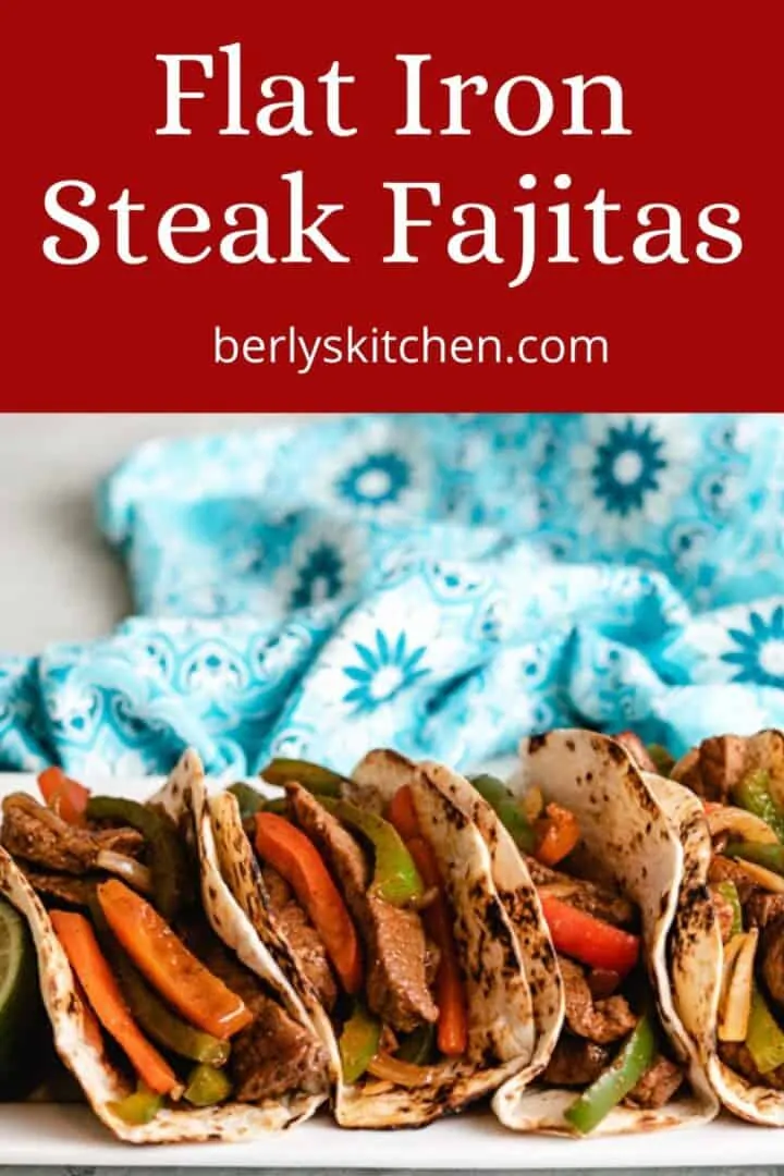 Flat iron steak fajitas served on a rectangular platter.