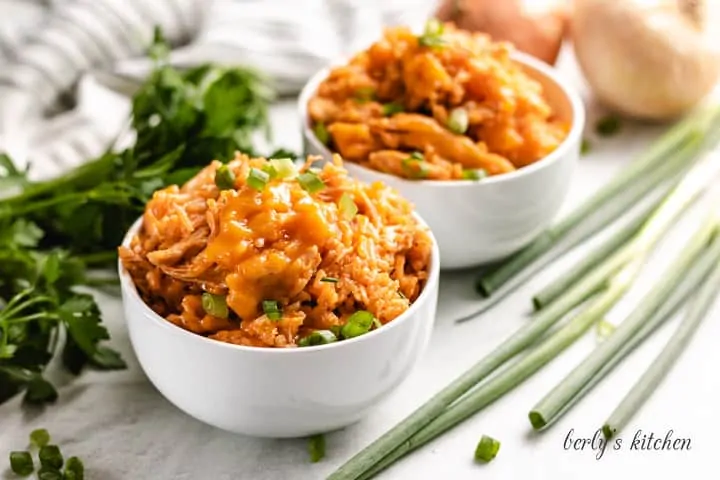 Two bowls of buffalo chicken and rice.