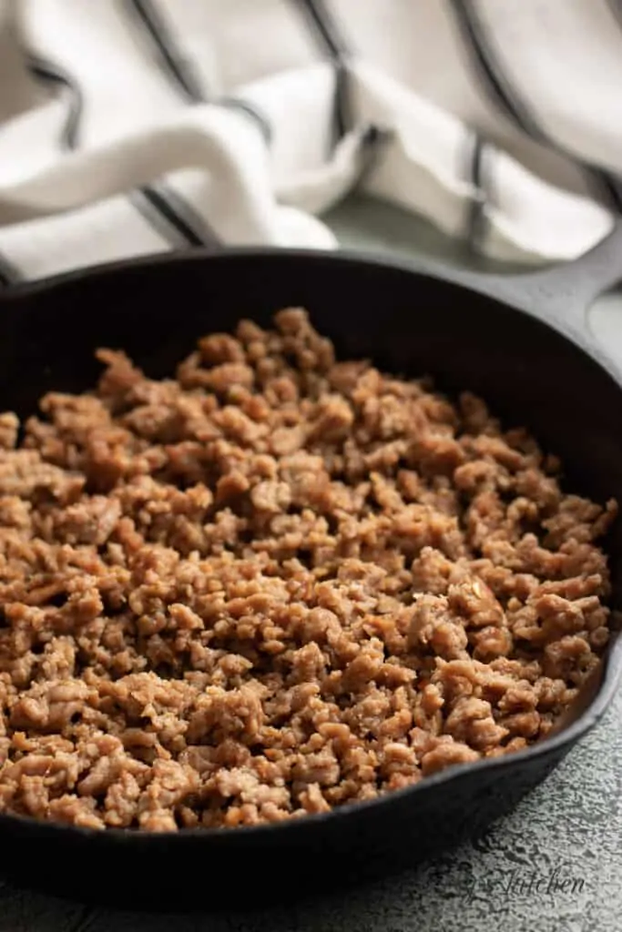 Italian sausage cooked in a cast iron skillet.