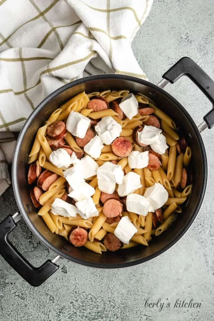 Cubed cream cheese added to the cooked noodles.