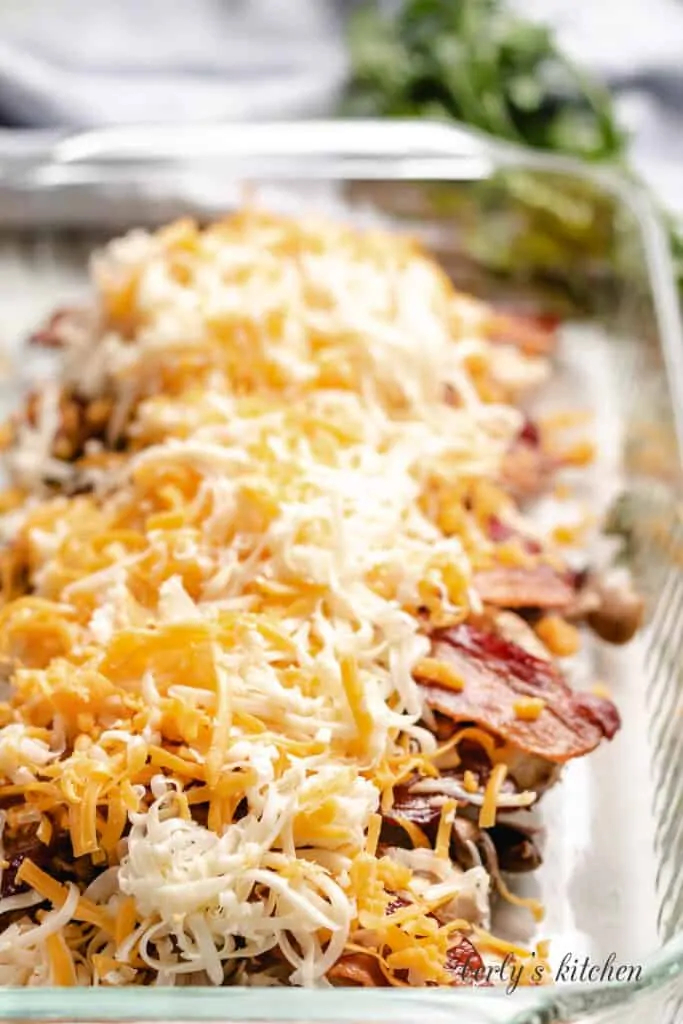 Shredded cheese sprinkled over the bacon.