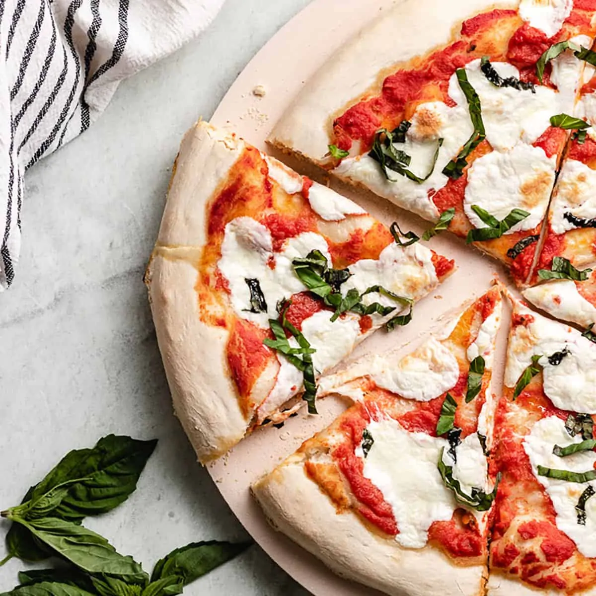 A slice of the margherita pizza cut from the pie.