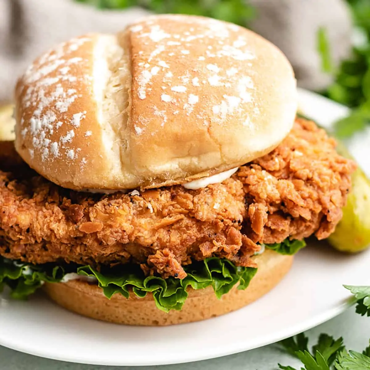 The spicy chicken sandwich served with a pickle.