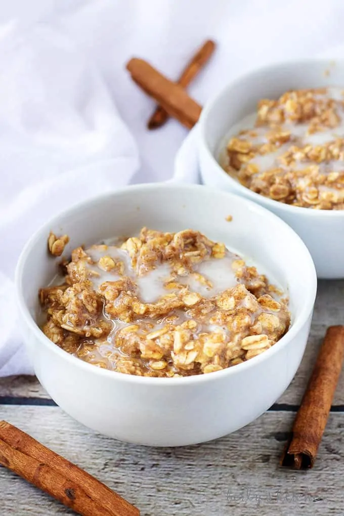 Two white bowls with cinnamon oatmeal.