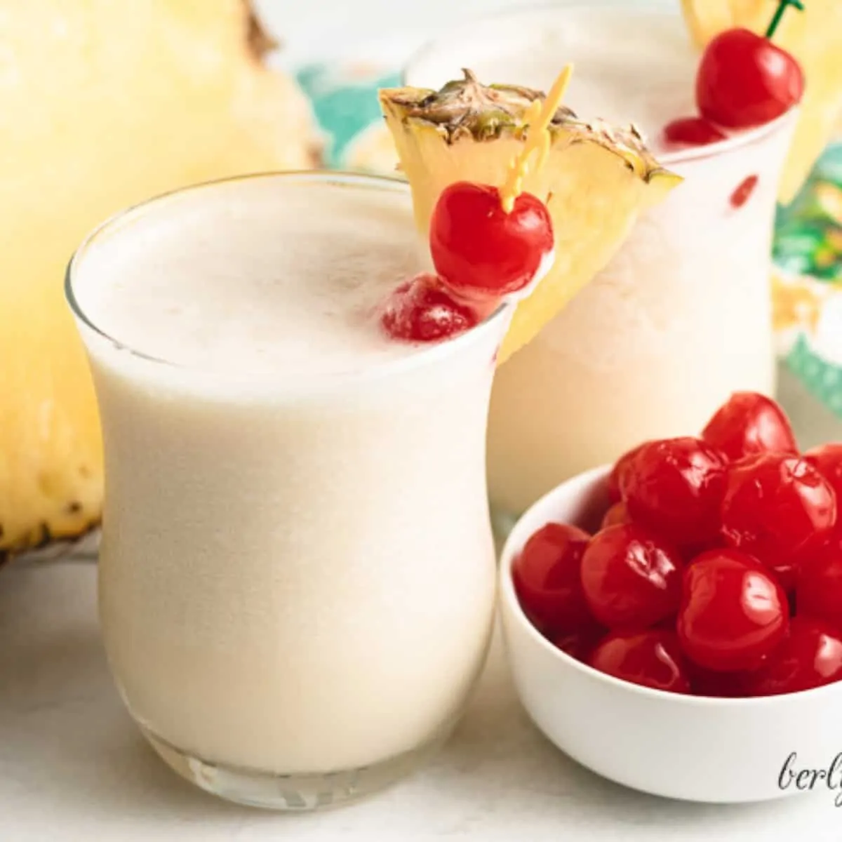 Two henny colada cocktails in small glasses.