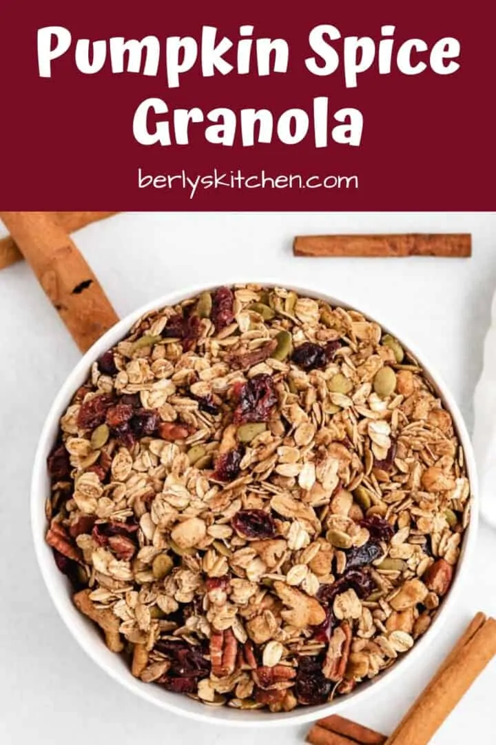 A aerial view of the pumpkin granola surrounded by cinnamon sticks.