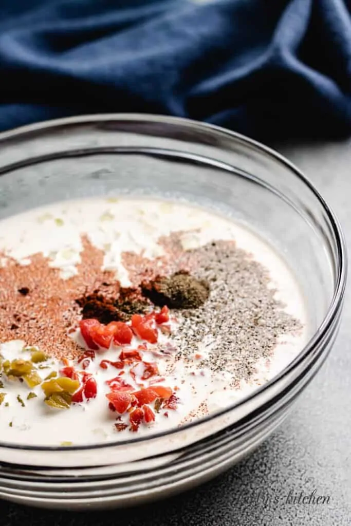 Eggs, heavy cream, and other ingredients in a mixing bowl.