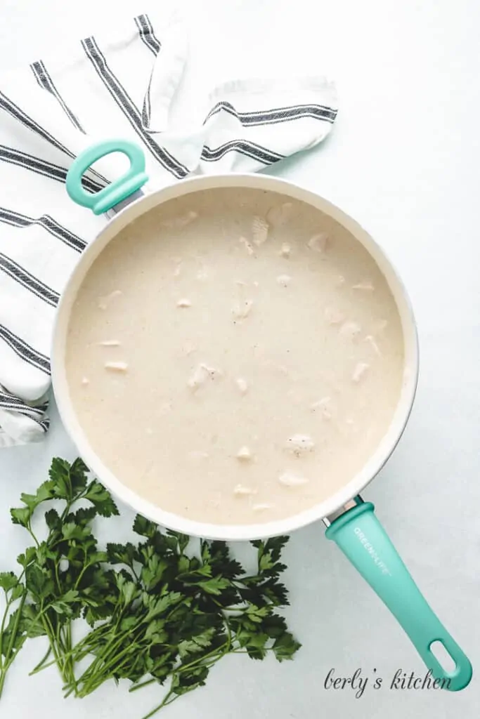 Canned soup and broth added to the pan.