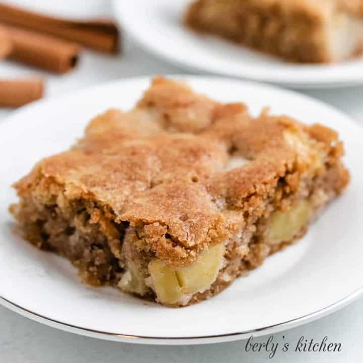 A slice of fresh apple cake on a plate.
