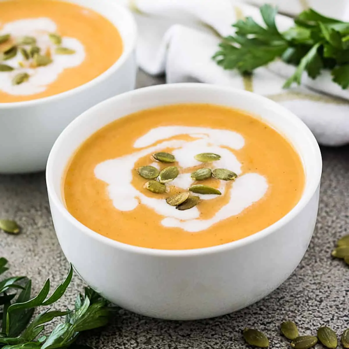 Squash soup in a white bowl.