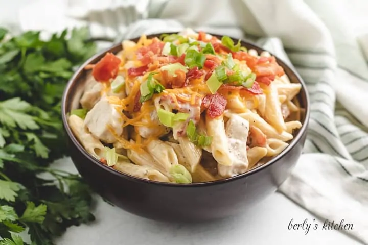 Pasta with bacon and chives in a bowl.