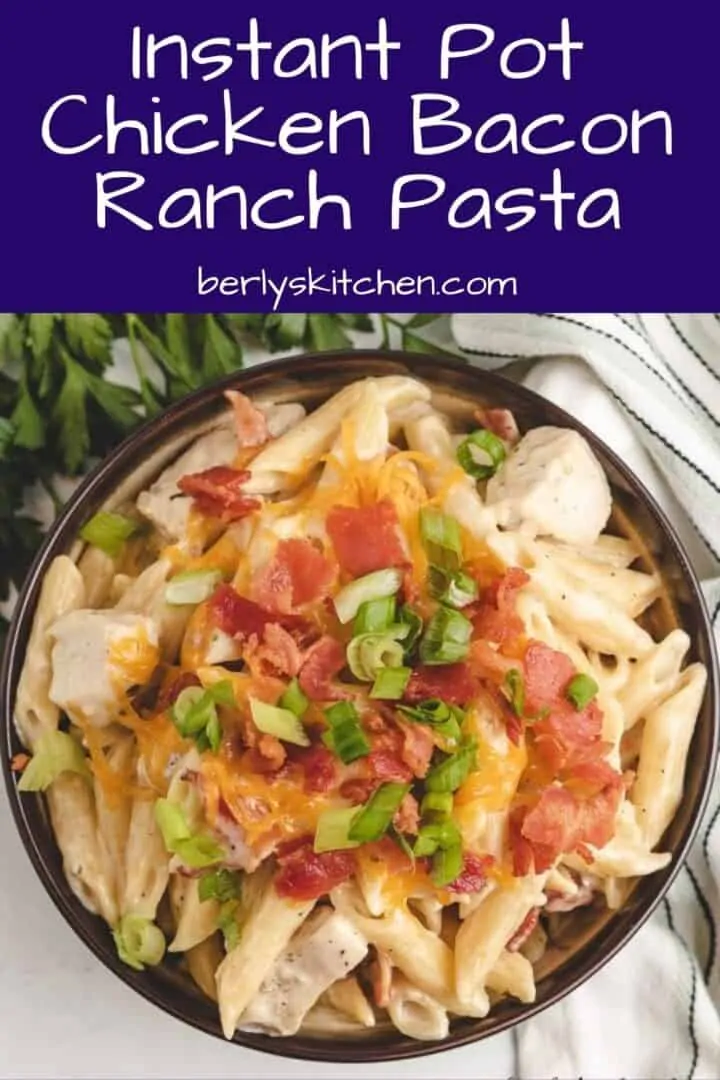 Top down view of pasta with bacon and green onions.