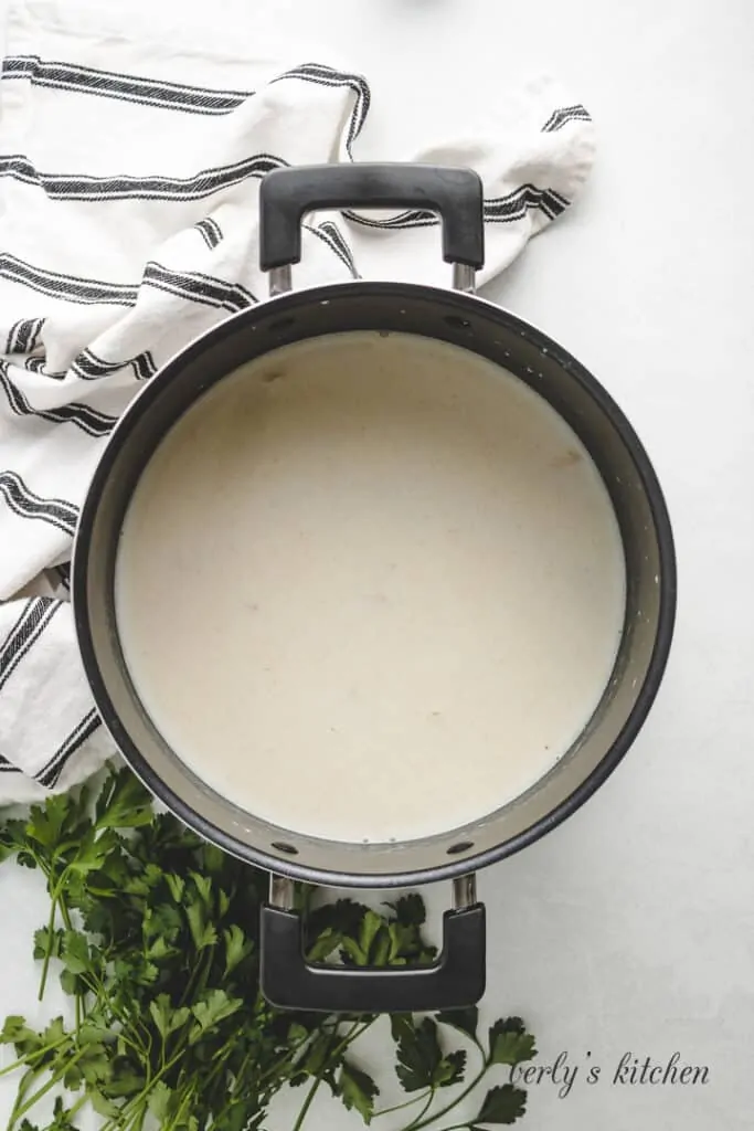 Broth and milk added to the butter flour mixture.