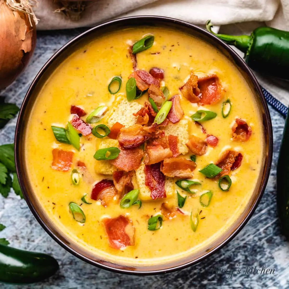 An aerial view of the beer cheese soup in a bowl.