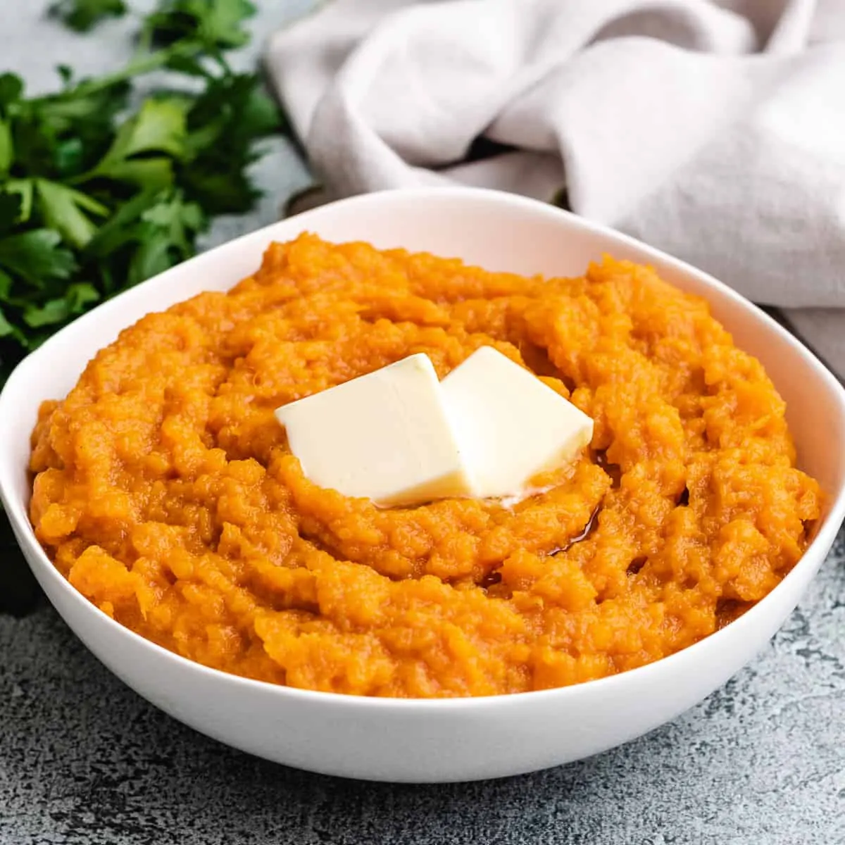 Instant pot mashed sweet potatoes served with butter.