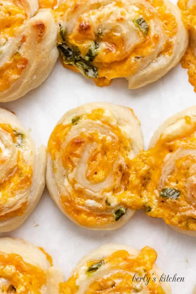 A top-down view of baked rolls on a pan.