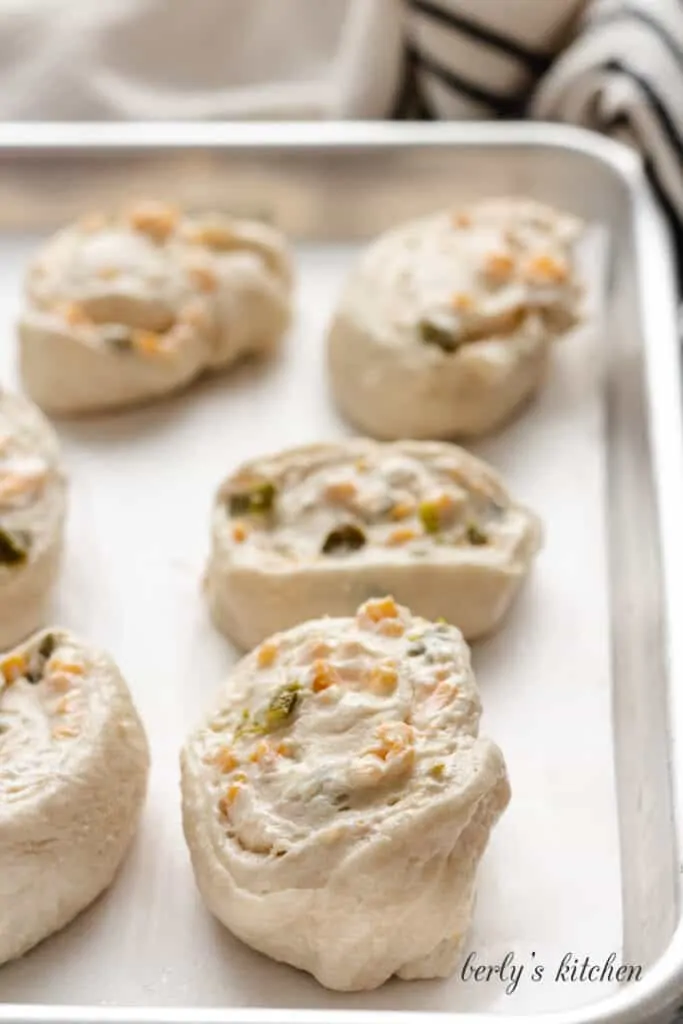 The rolls have been cut and placed on the sheet pan.