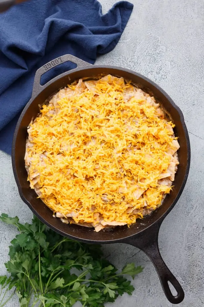 Shredded cheese added to the skillet.