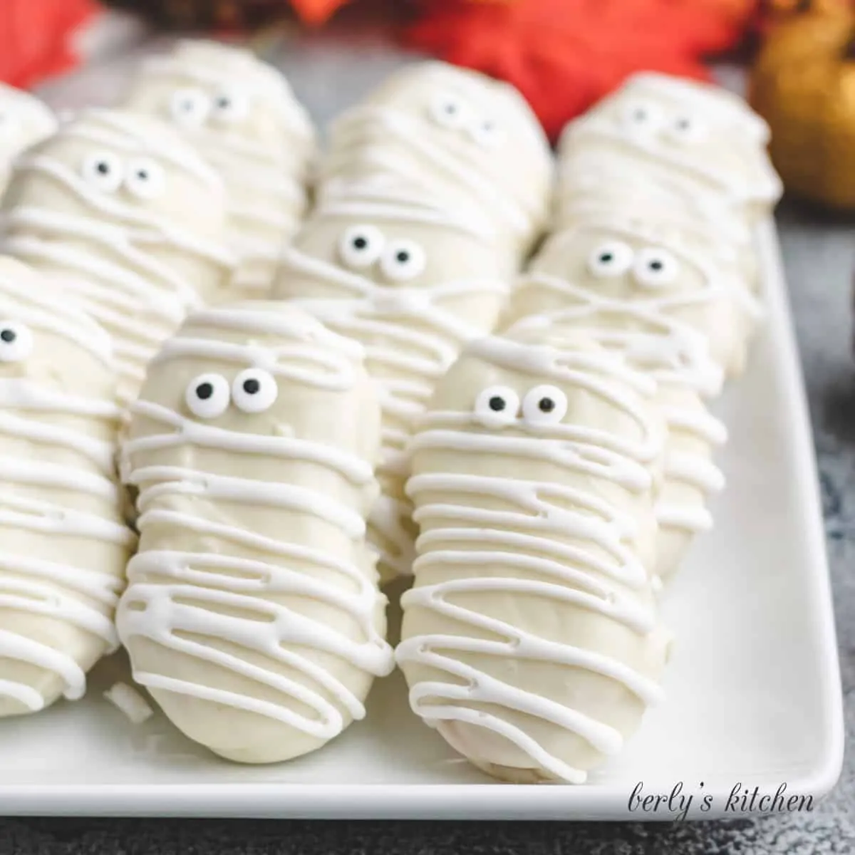 A plate of decorated nutter butter mummy cookies.