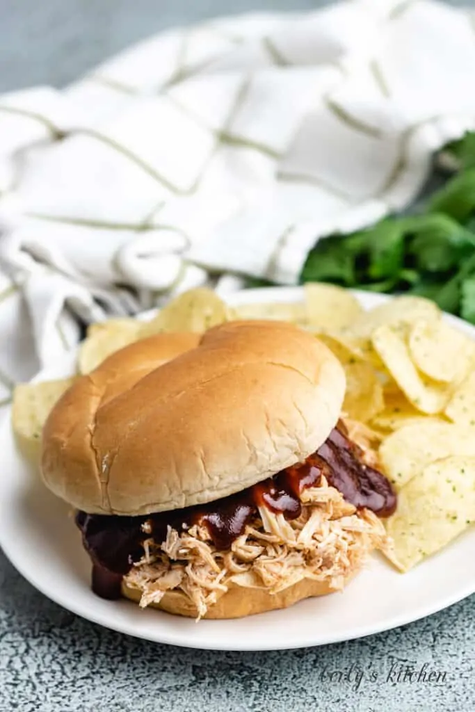 The finished chicken sandwich with bbq sauce.