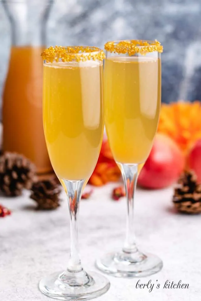 Two cocktails in glasses garnished with sugar.