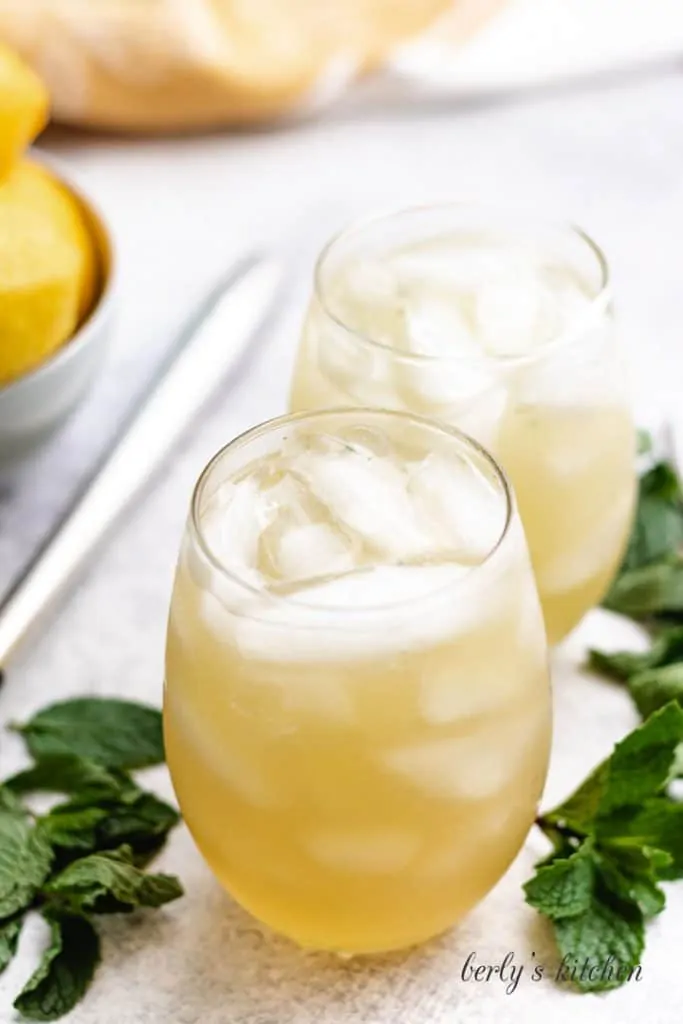 Two cocktails in glasses with ice.