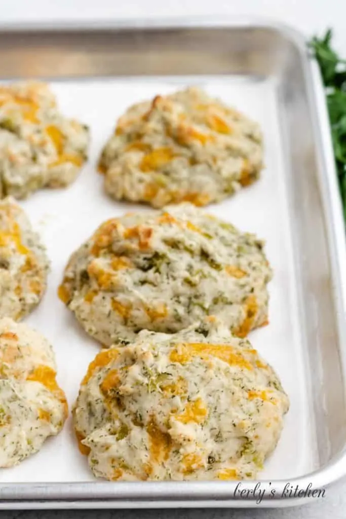 Close-up view of the fresh baked biscuits on a pan.