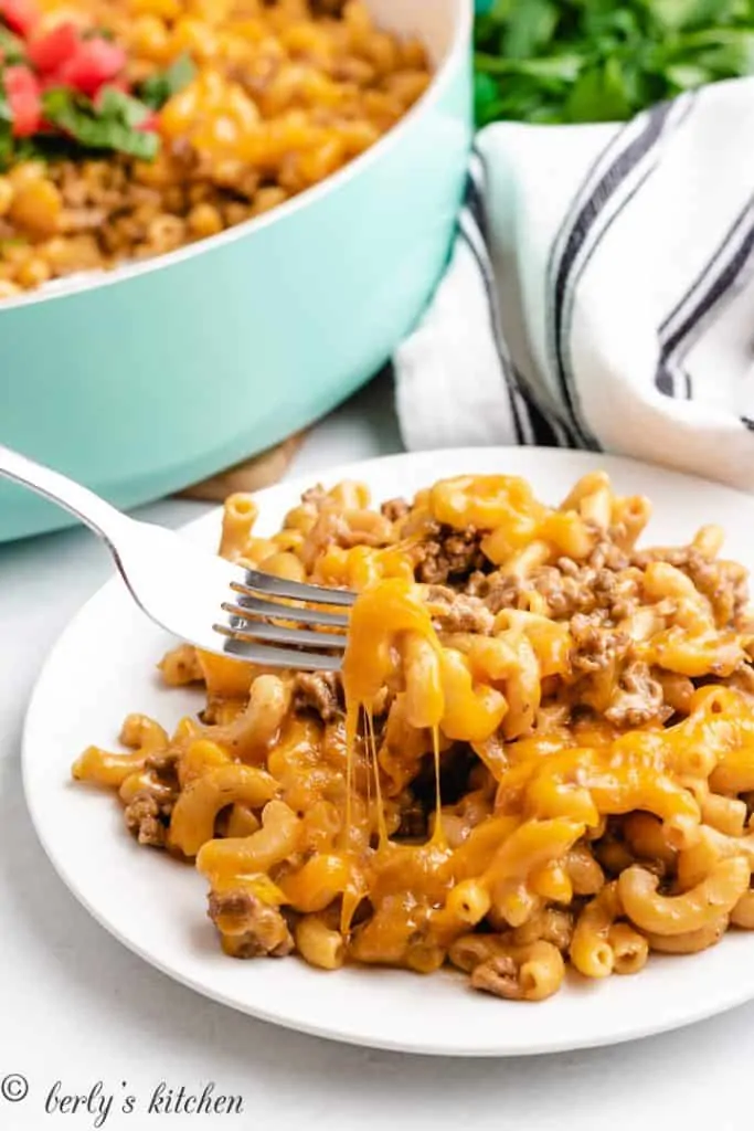 A portion of the casserole being eaten with a fork.