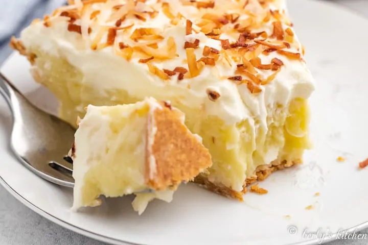 A piece of the coconut cream pie cut with a fork.