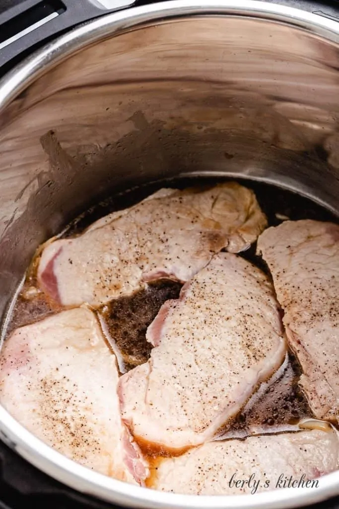 The chops put back into the pot to pressure cook.