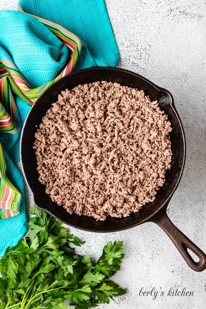 Cooked ground beef in a cast iron skillet.