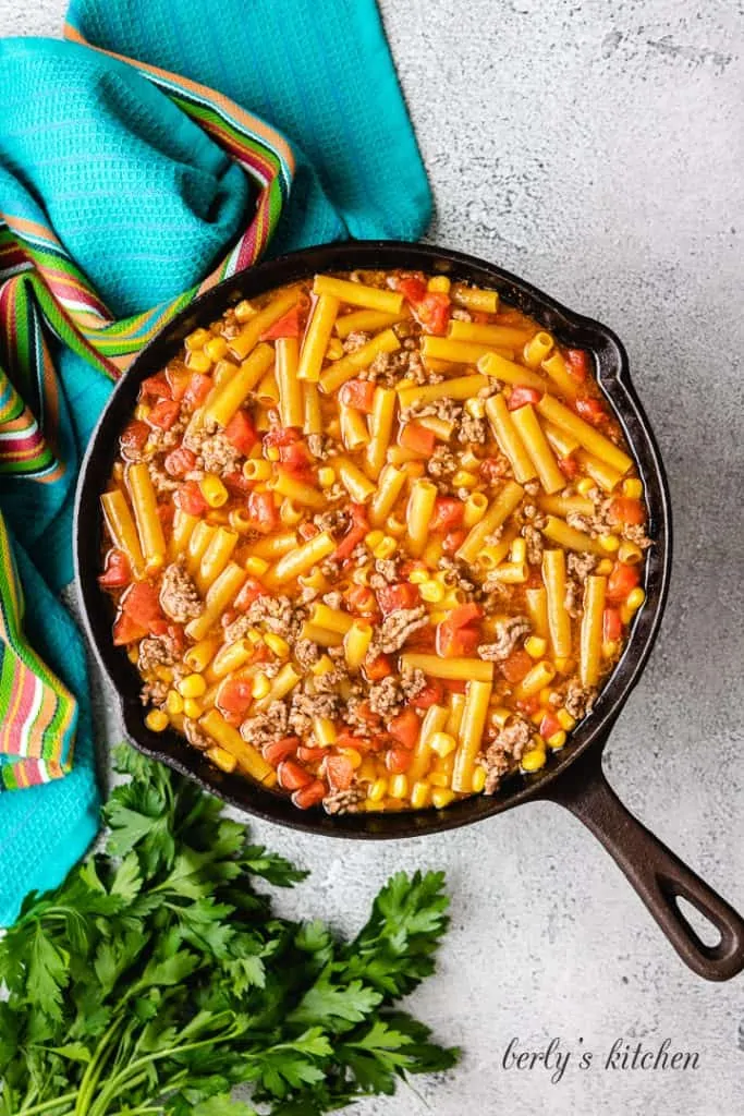 Dry pasta noodles added to the skillet.